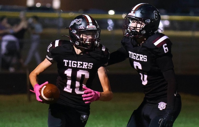 Kaden Scheppelman (10) of Dupo makes the touchdown reception and celebrates with Evan Acord (6) against Wesclin at Dupo High School on Friday, September 19, 2024. Paul Baillargeon